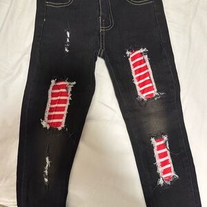 Stylish Black Distressed Jeans with Red Accents
